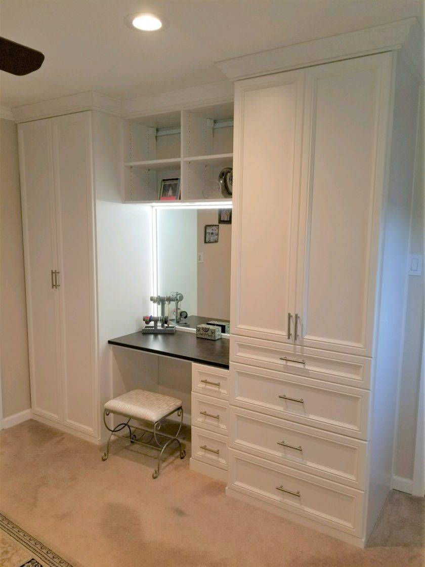 This bedroom built-in in Livingston, NJ incorporates an LED lit vanity, long and regular hang space along with drawers for folded items.