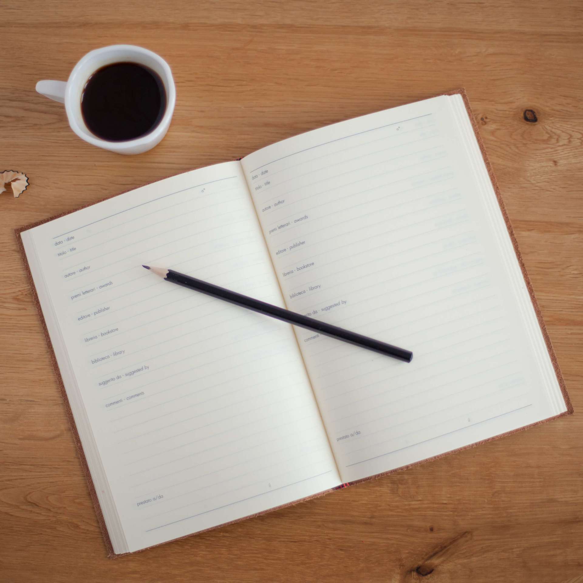 funeral pre-planning services book coffee pencil on table