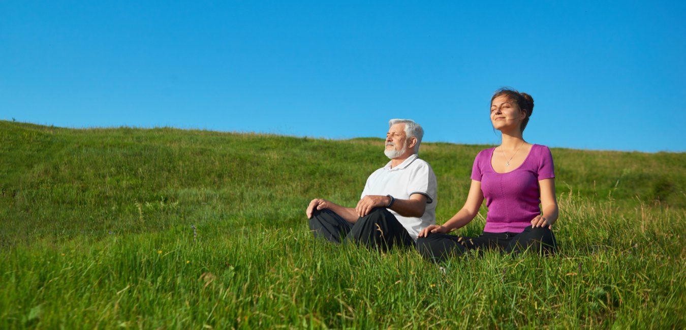 Older man and woman on grass