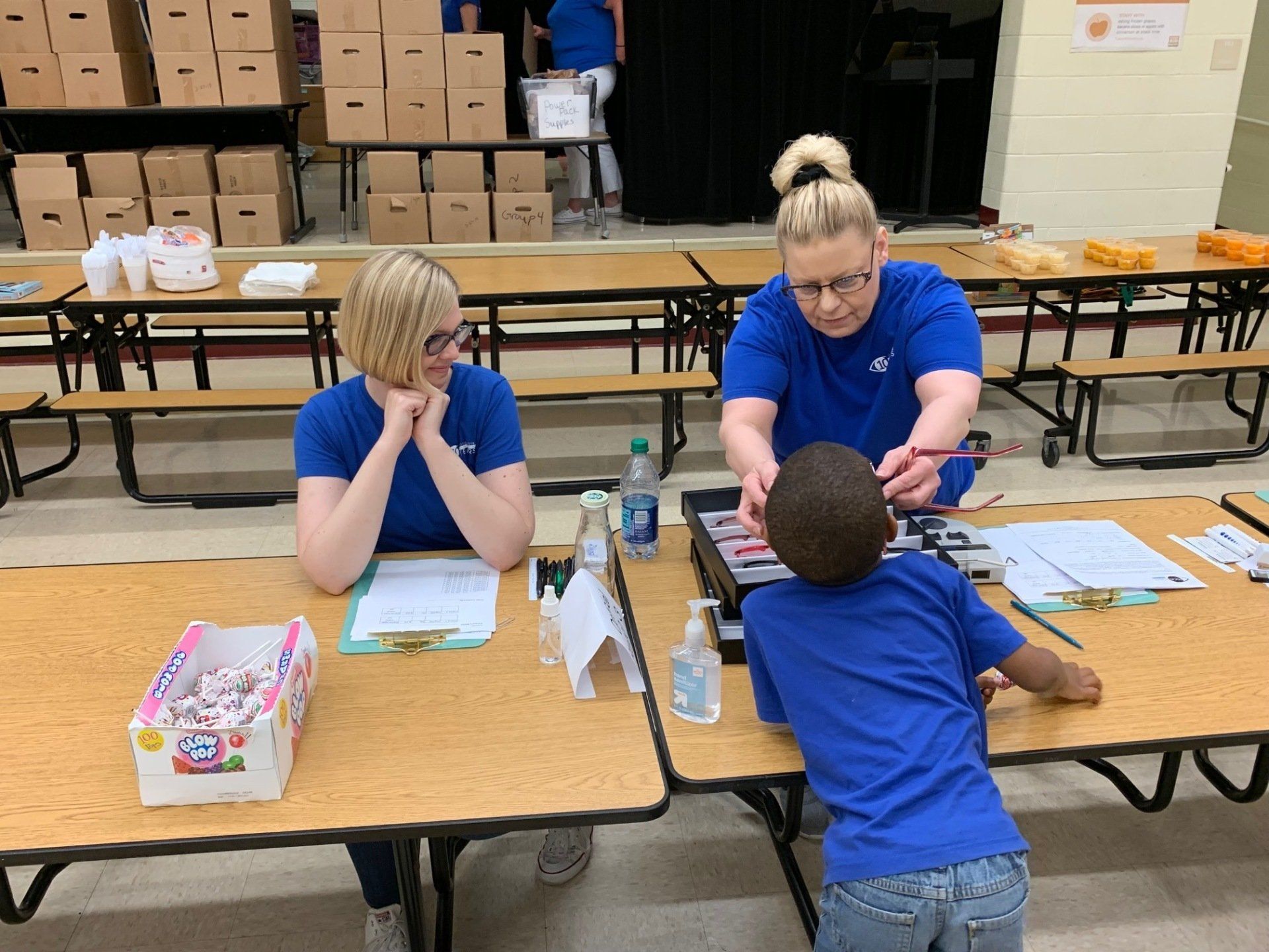 Focal Pointe Eye Care team fitting child with glasses