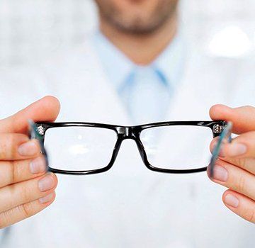 man holding glasses