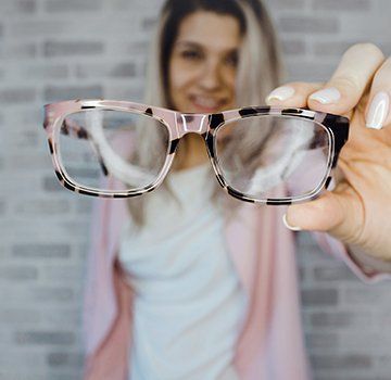 girl holding eyeglass
