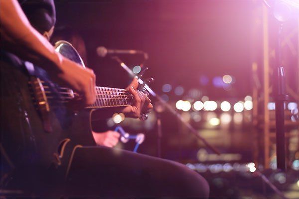 Man playing guitar in live show Man playing guitar in live show