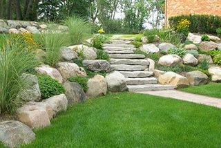 Stone Retaining Wall With Grass — Landscaping in Shelby Township, MI Stone Retaining Wall With Grass — Landscaping in Shelby Township, MI