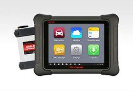 Diagnostic tablet with interface icons and a connecting device on a white surface.
