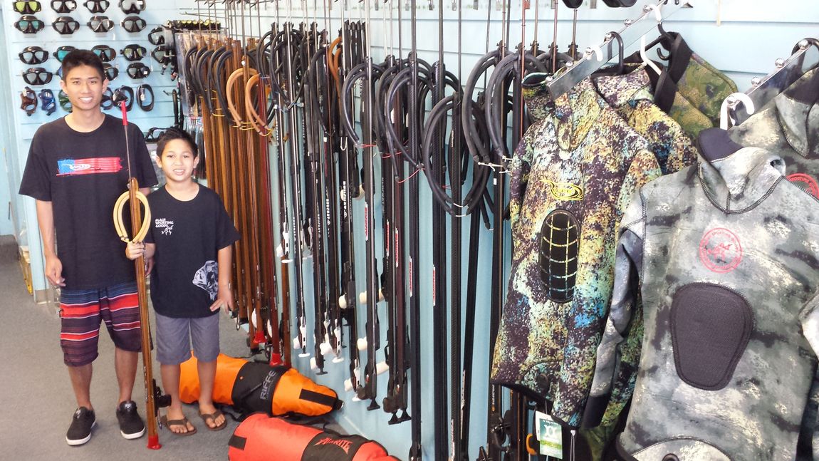 Diver with spear doing spearfishing in Honolulu, H