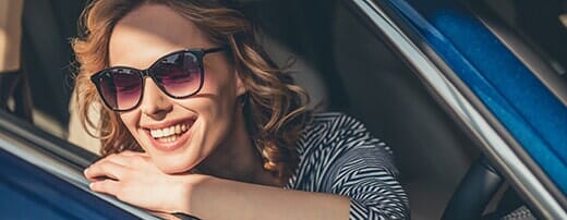 Smiling Woman inside a car — Automotive Repair in Kinston, NC Smiling Woman inside a car — Automotive Repair in Kinston, NC