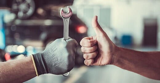 Worker with a wrench and a thumb up — Automotive Repair in Kinston, NC Worker with a wrench and a thumb up — Automotive Repair in Kinston, NC