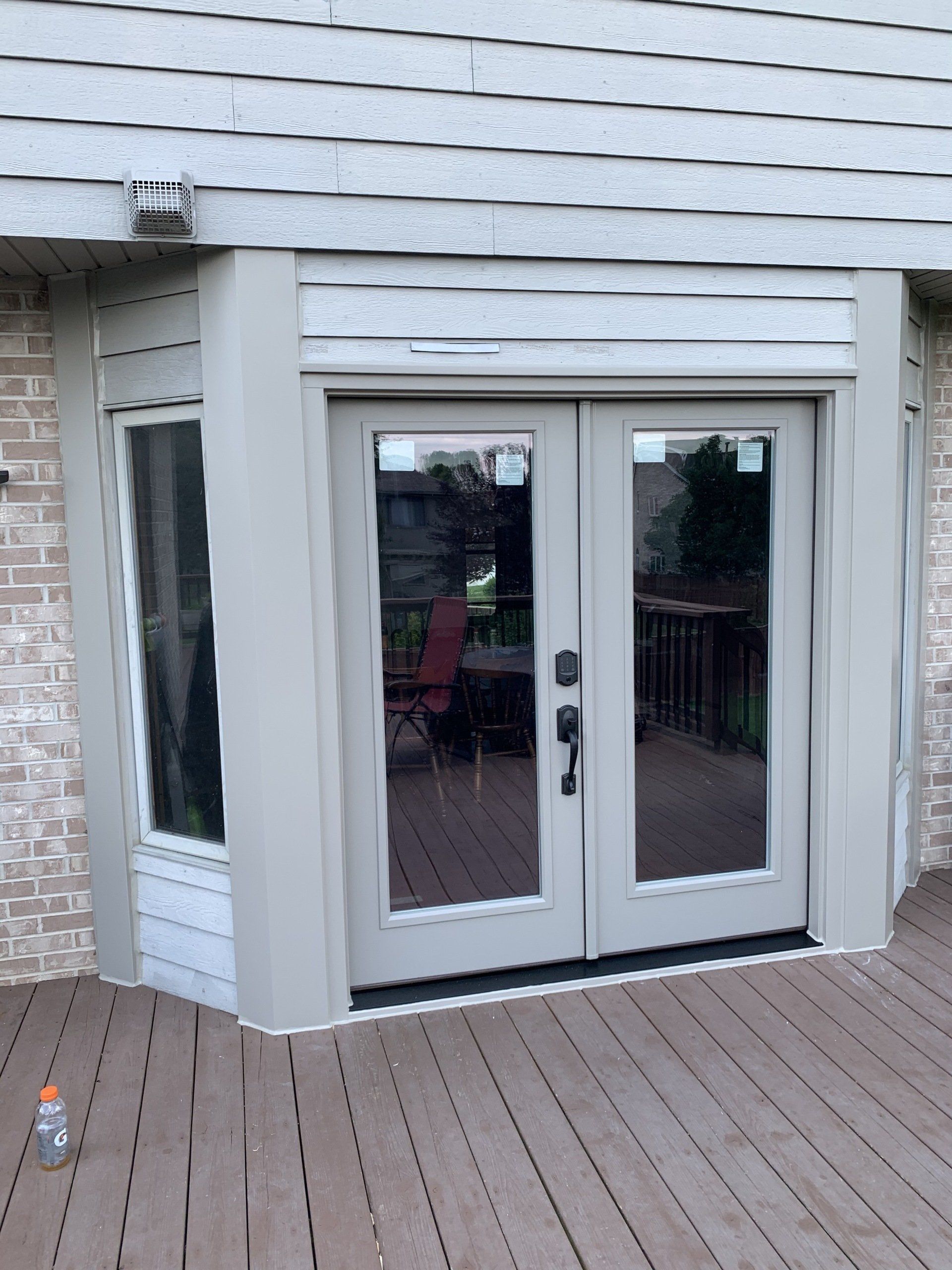 A house with a deck and a sliding glass door