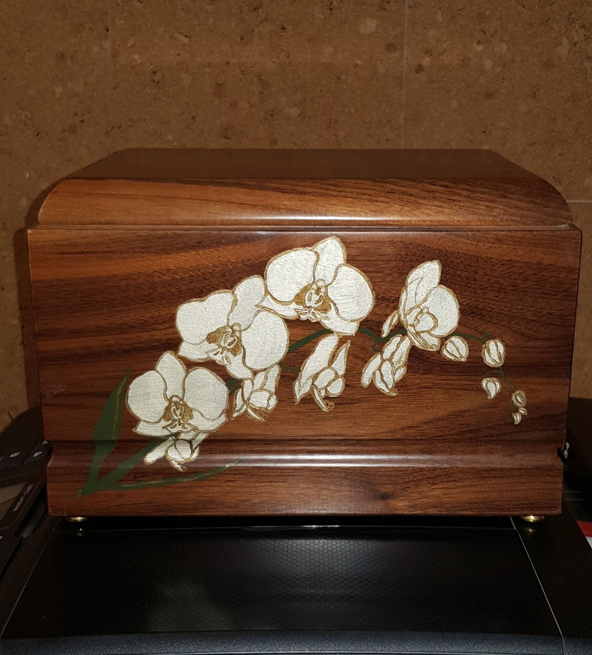 Urna in legno con motivo a orchidea bianca.