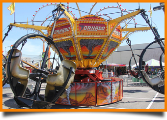 A carnival ride that says tornado on it