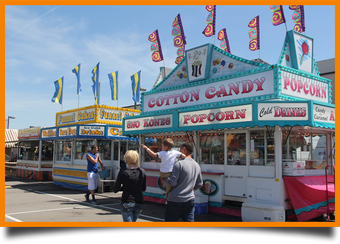 A cotton candy and popcorn stand at a carnival