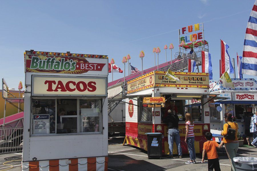 A tacos booth is next to a burrito booth