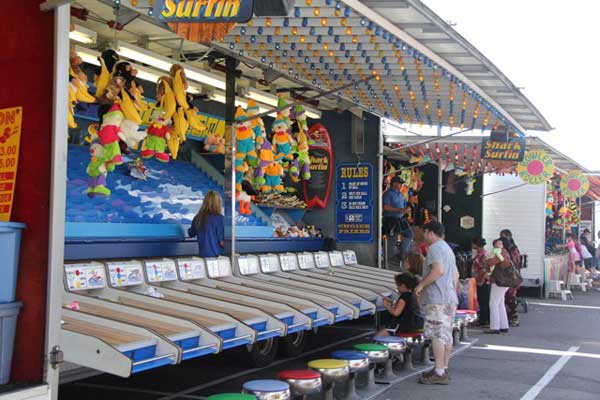 People are playing a game at a carnival called surfing