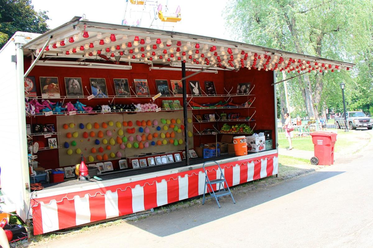 A carnival booth with a red and white striped awning