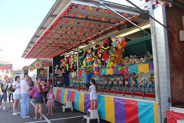 A group of people are playing a game at a carnival