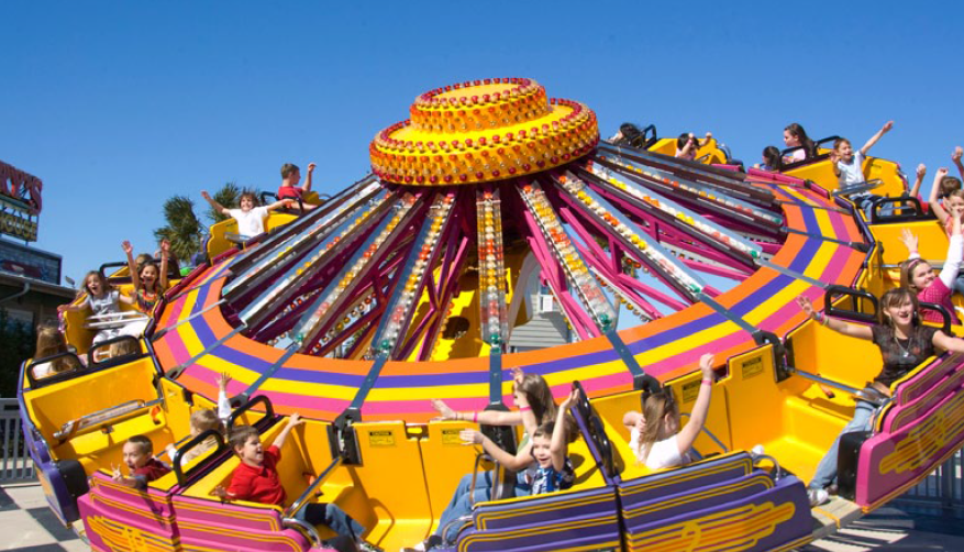 A group of people are riding a ferris wheel at an amusement park