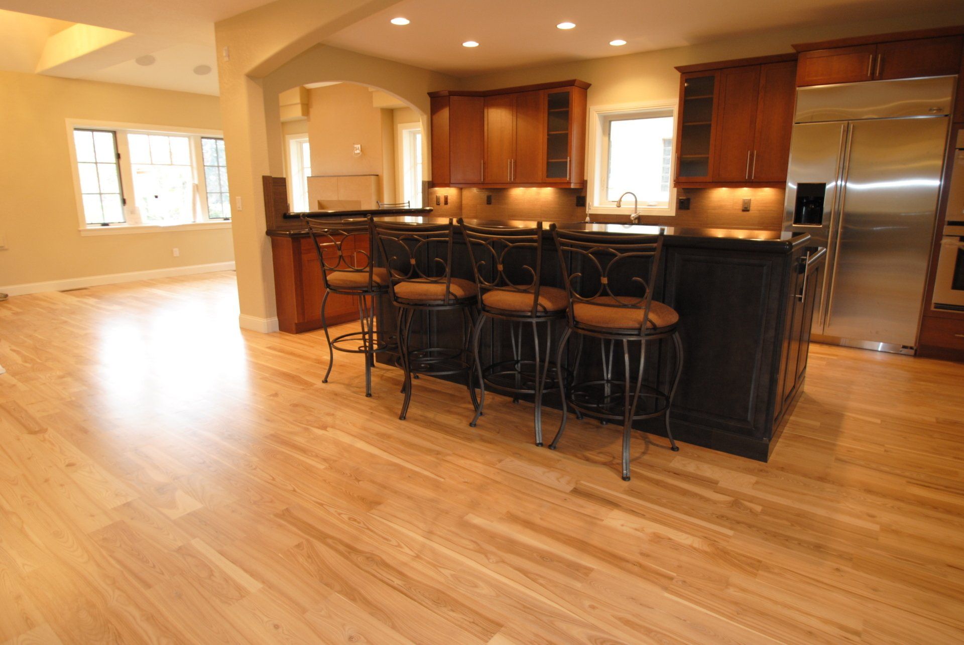 Brown Kitchen Cabinets and Black Kitchen Island — Denver, CO — All City Floor Co
