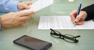 Businessman Signing Contract — Business Insurance in Bristol, RI Businessman Signing Contract — Business Insurance in Bristol, RI
