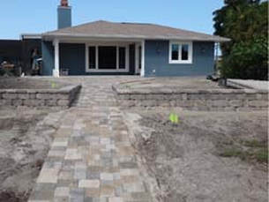 House with Retaining Wall Outside — Sarasota, FL — Custom Pavers of Southwest Florida