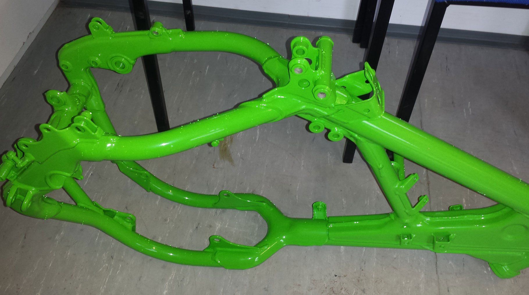 Motor bike coated in a custom green and then lacquered