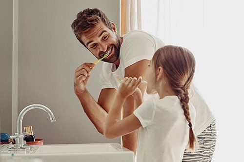 Dental Hygiene Father and Daughter brushing teeth