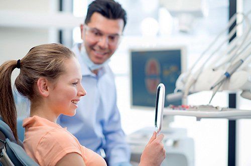 Woman exmining her smile