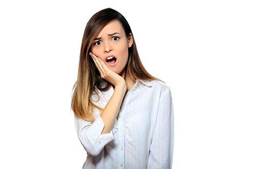 Emergency Dentistry Young lady holding jaw