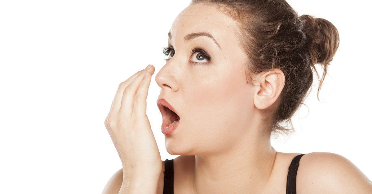 woman smelling breath