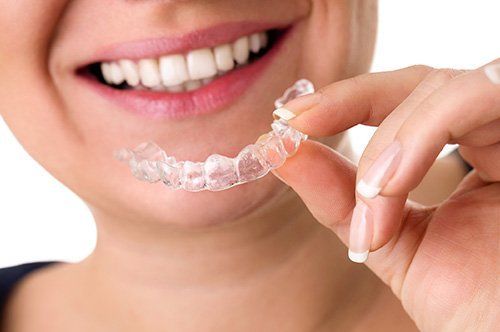 Woman holding invisalign