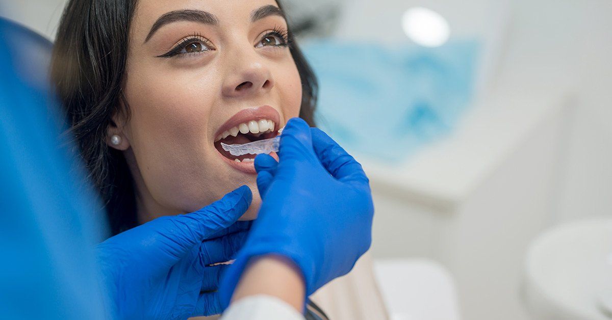 woman about to wear invisalign tray