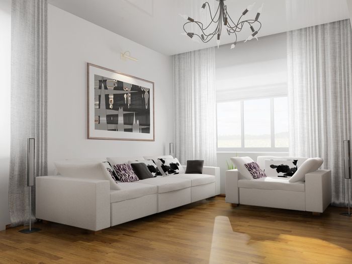 Soft white curtains open in loungeroom, with white couches on timber floor, picture on wall and arty light fighting centerpiece.