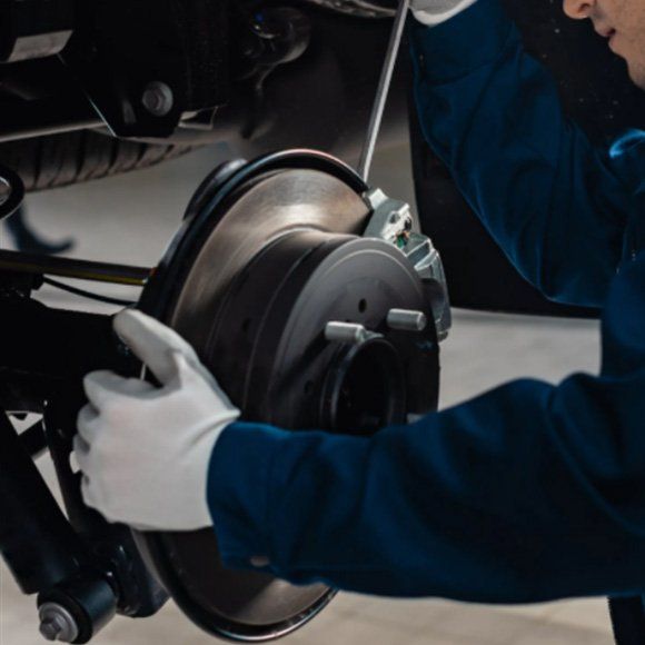Mechanic Checking Brakes — Automotive Repair in Townsville Mechanic Checking Brakes — Automotive Repair in Townsville