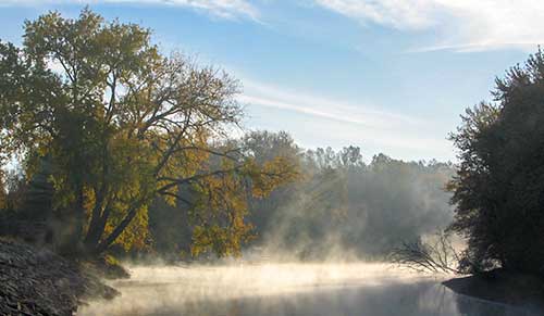 The Wolf River in Shiocton (at Bamboo Bend)  in early morning with fog rising from the river