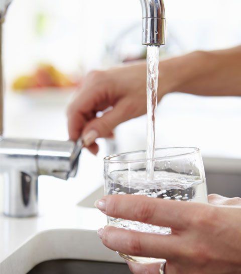 Pouring Glass of Water from Sink - Pump Repair in Central NY