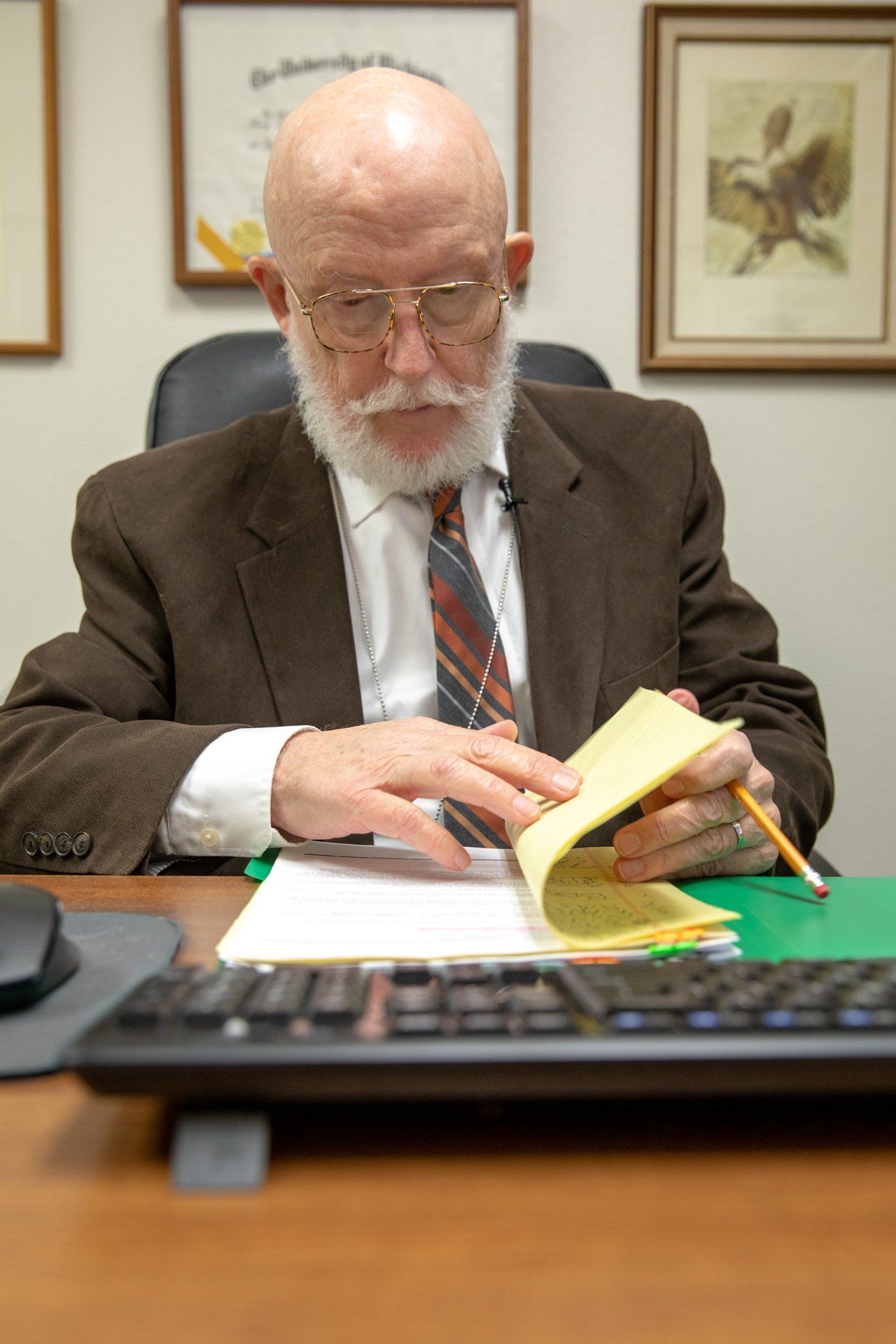 Man sitting at desk looking at papers