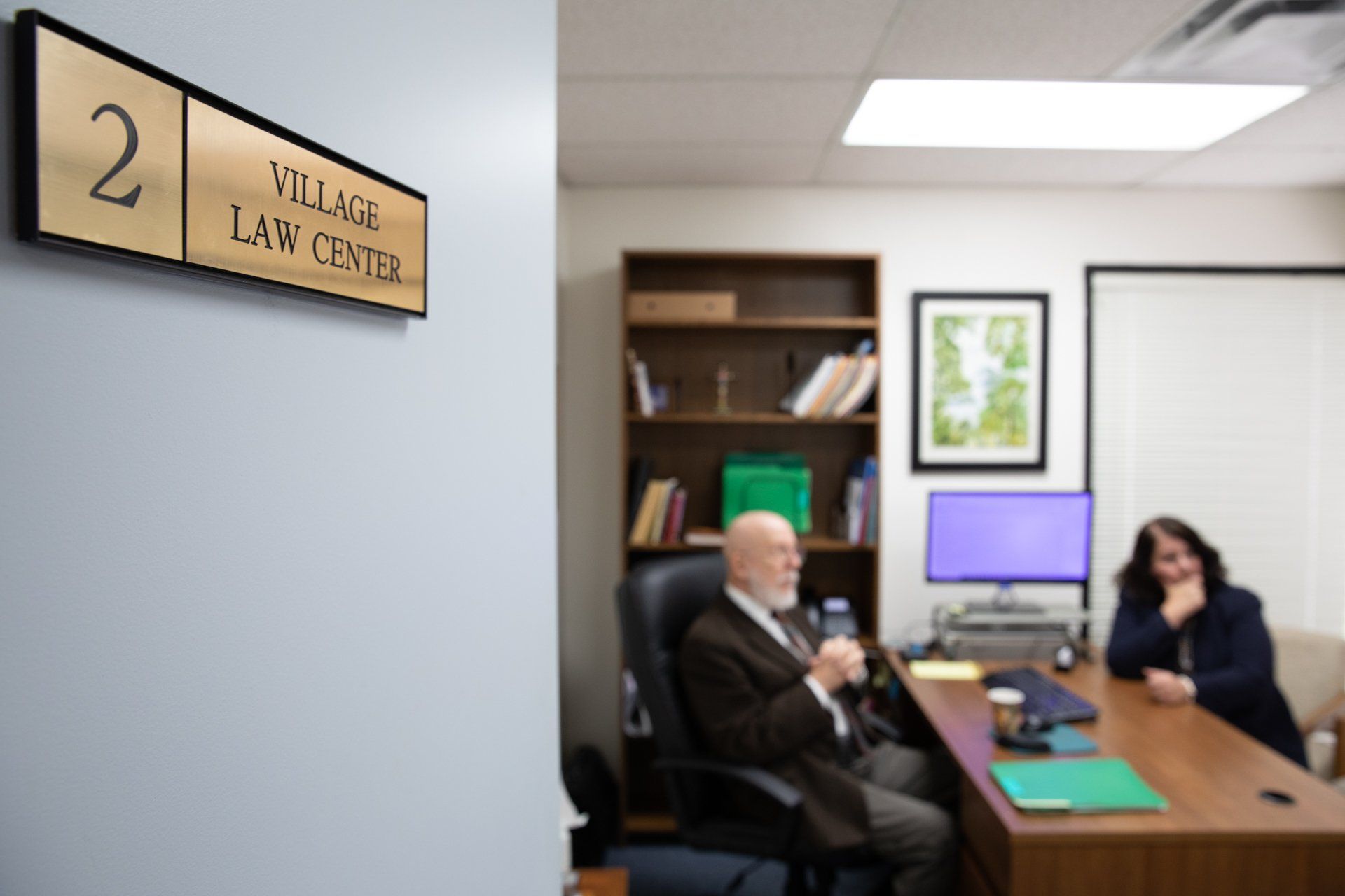 Two people in office discussing business