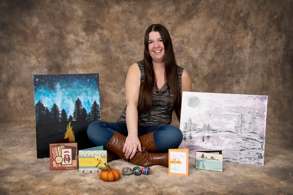 Brandi LeClair with her paintings. Xero Certified Bookkeeper
