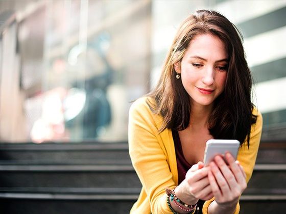 Teen Girl Looking at Cellphone & Smiling