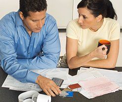 young couple working out tax returns