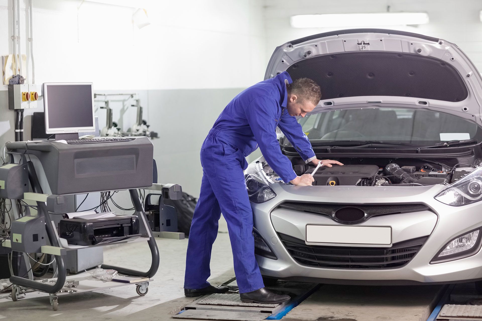 mechanic looking at transmission