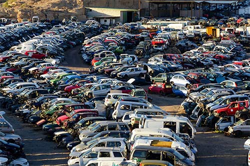 Scrap Yard with Pile of Crushed Cars — Corpus Christi, TX — Advantage Salvage & Auto Parts LLC Scrap Yard with Pile of Crushed Cars — Corpus Christi, TX — Advantage Salvage & Auto Parts LLC