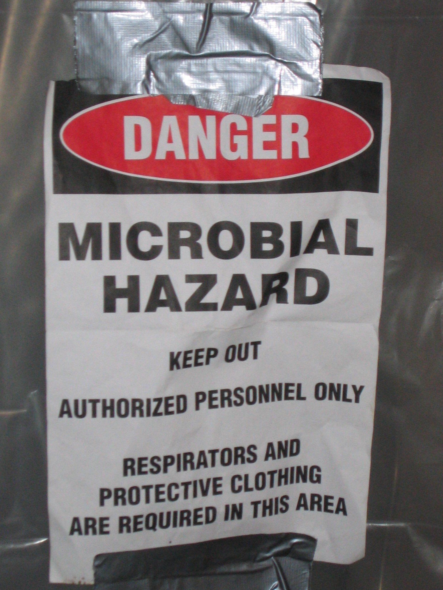 A sign that says danger microbial hazard on it