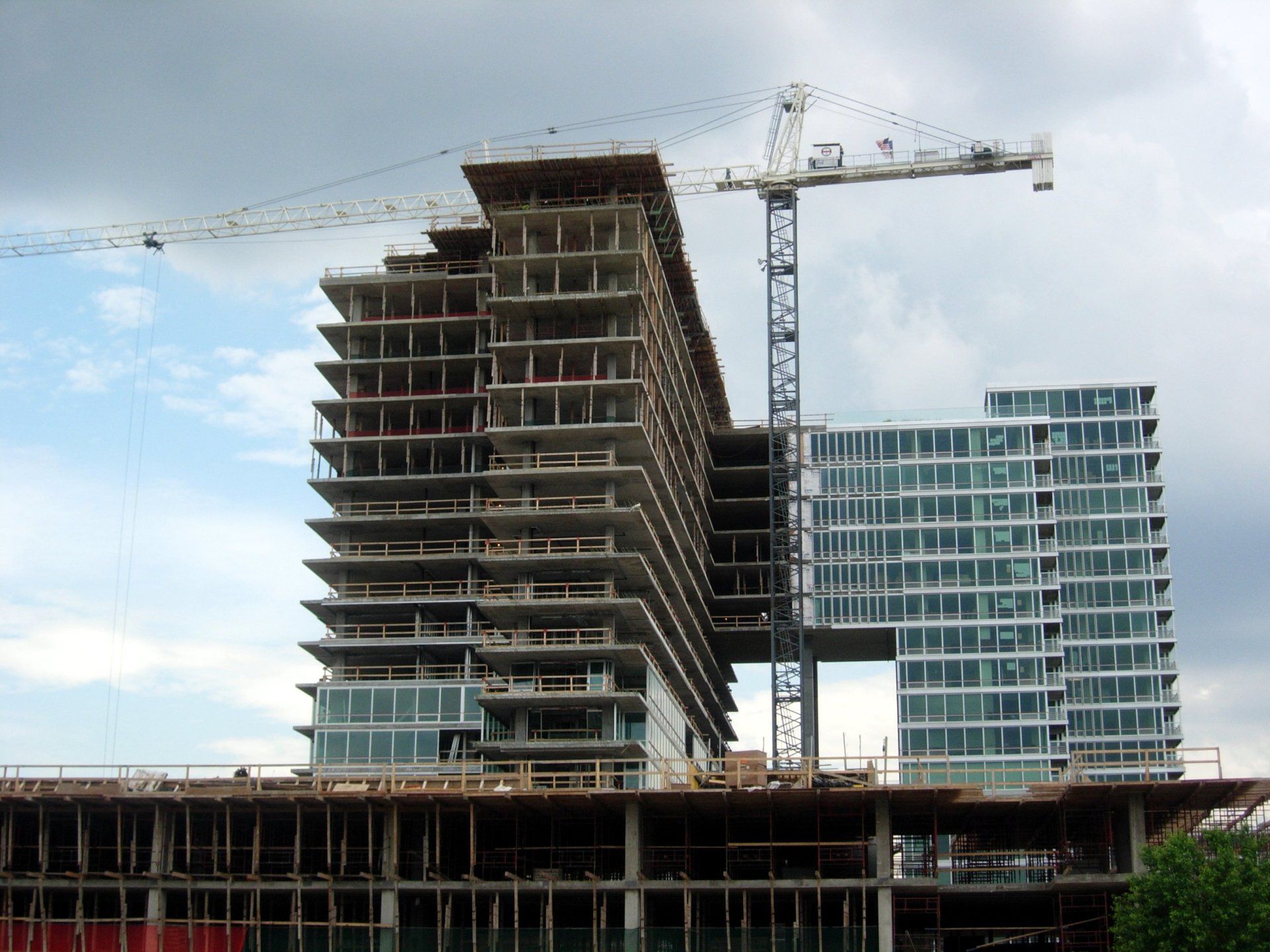A large building under construction with a crane in the foreground