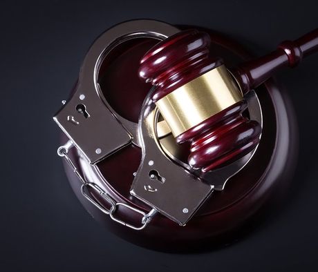 Wooden Judge Gavel And Police Handcuffs — Pocatello, ID — Debbie’s Bail Bonds Wooden Judge Gavel And Police Handcuffs — Pocatello, ID — Debbie’s Bail Bonds