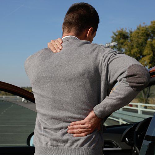Muscle Pain — Man With Muscle Pains After Long Drive in Concord, CA Muscle Pain — Man With Muscle Pains After Long Drive in Concord, CA