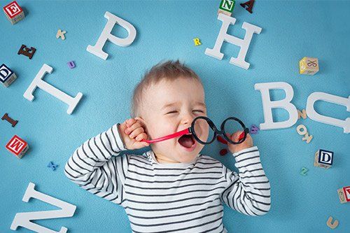 Child Lying With Letters On Surrounding