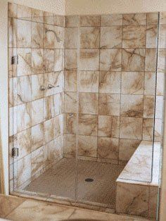 Corner shower with brown tile and glass doors
