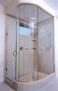 Corner shower enclosure with rounded glass door