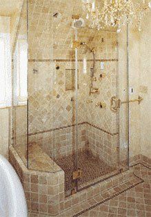 Light brown, tile shower enclosure with glass door